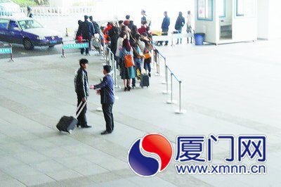 黑衣男子拉客，與正規(guī)出租車爭奪客源